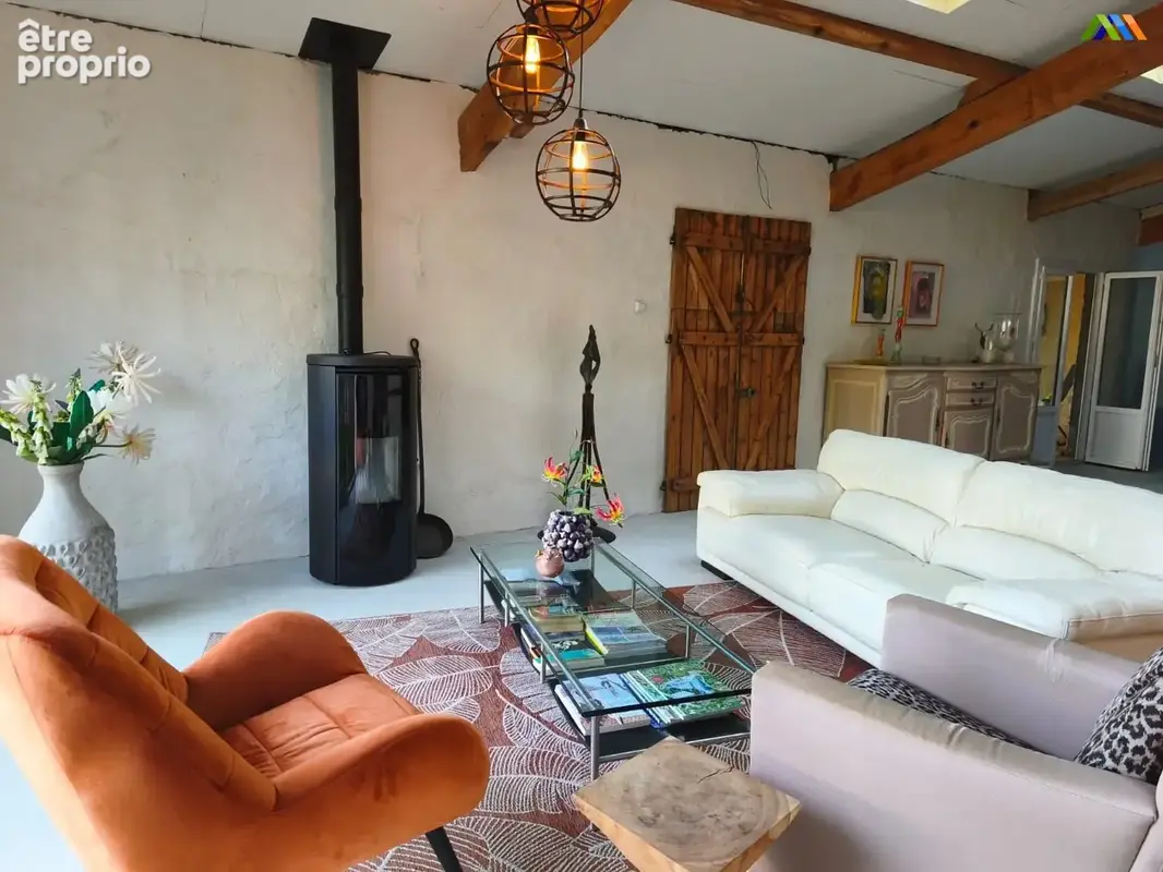 Comfortable reception room with wood-burning stove and exposed beams