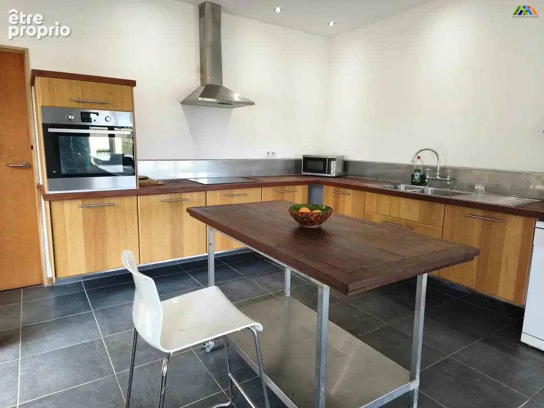 Modern fitted kitchen with central island and generous workspace.