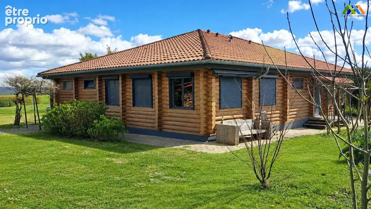 Wooden chalet exterior with garden, lawn and surrounding greenery.