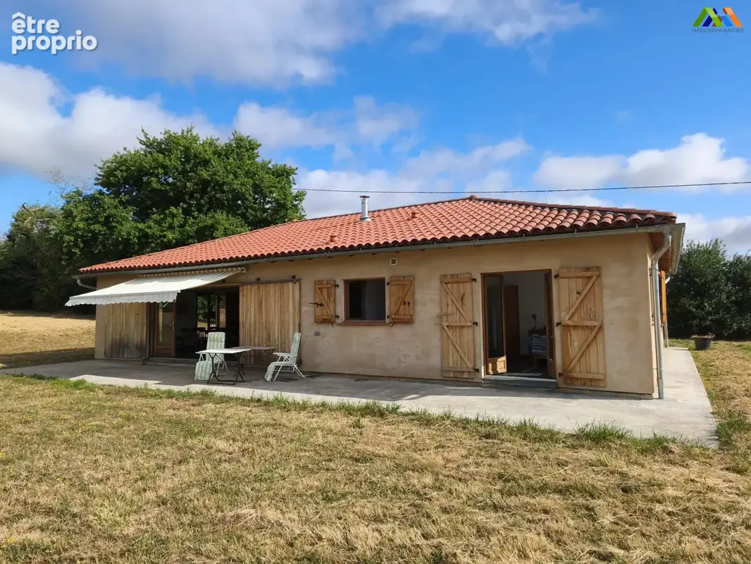 Rear elevation of the modern house with surrounding garden. - Maison à CASTELNAU-MAGNOAC