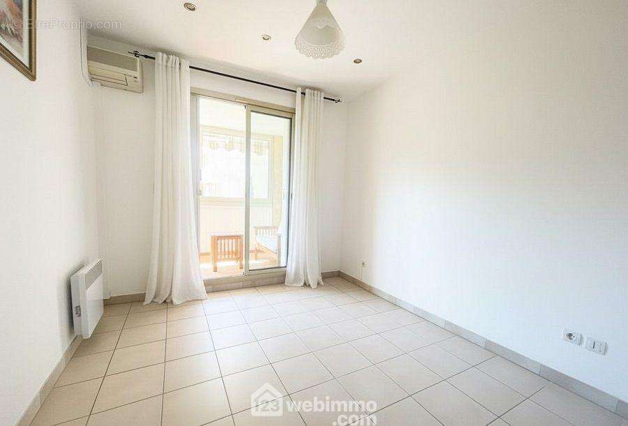 Chambre lumineuse avec accès extérieur, offrant calme et intimité. - Appartement à SAINTE-MAXIME