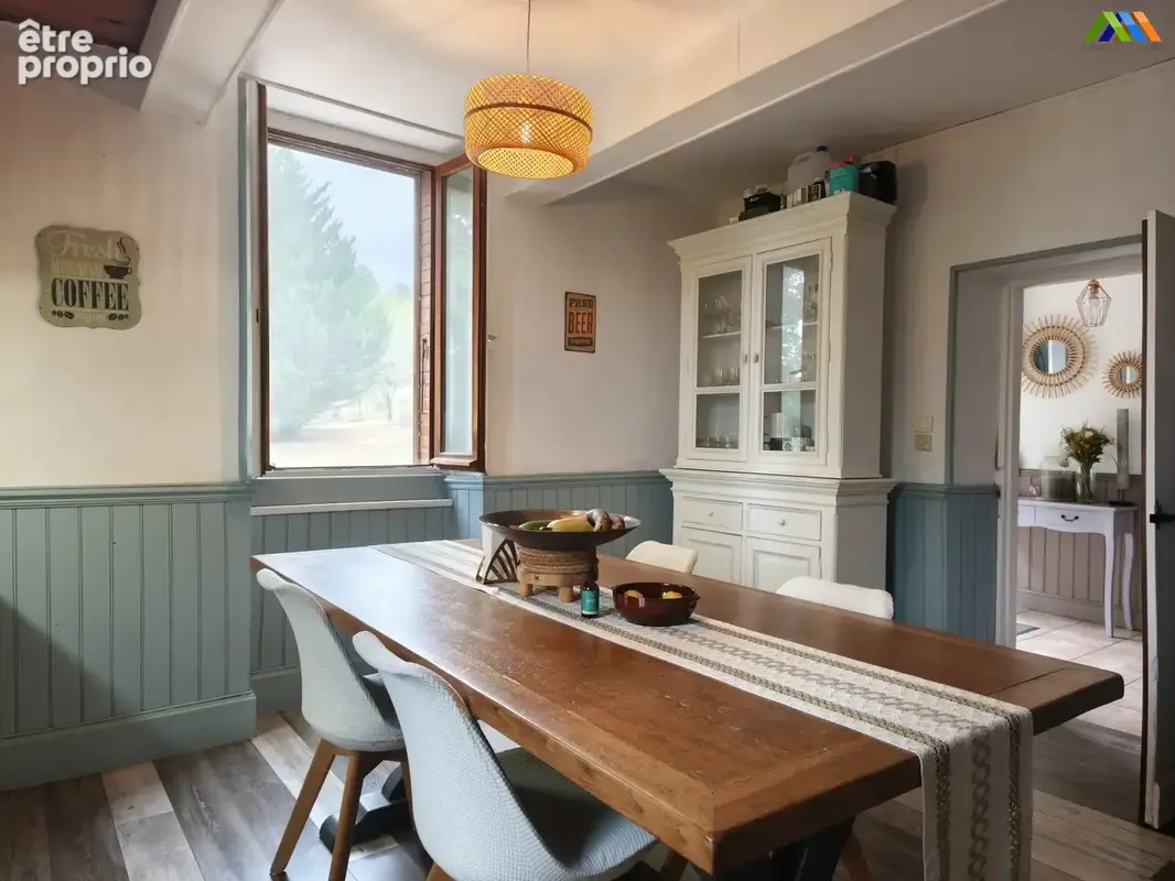 Traditional kitchen with central table and garden views