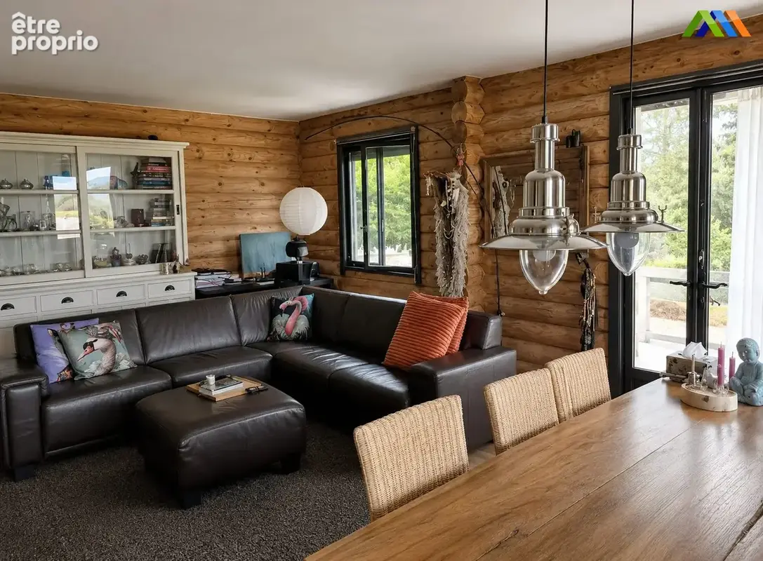 Bright and welcoming open-plan living and dining room in a characterful wooden chalet
