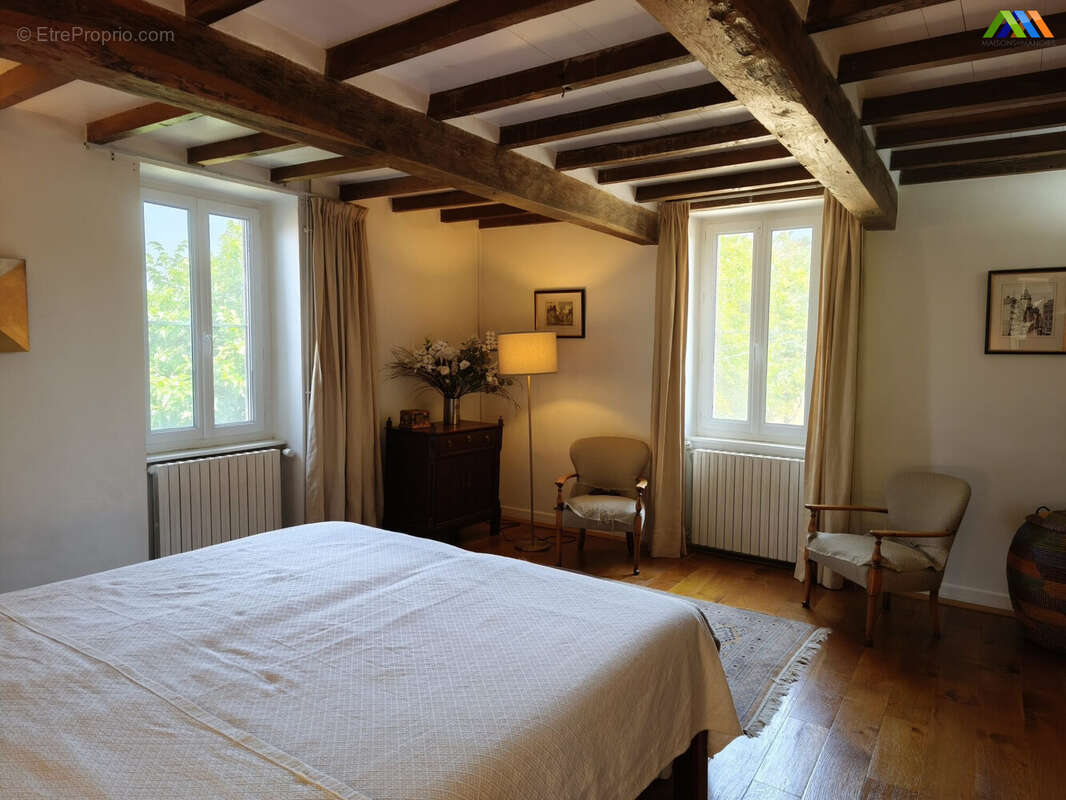 Spacious double bedroom with exposed beams and countryside charm.
