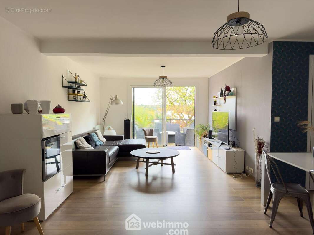 La pièce de vie de 34.40m² possède ... - Maison à CHOLET