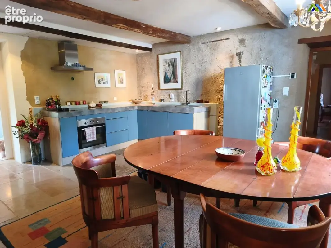 Bright kitchen and dining area with exposed beams and garden views