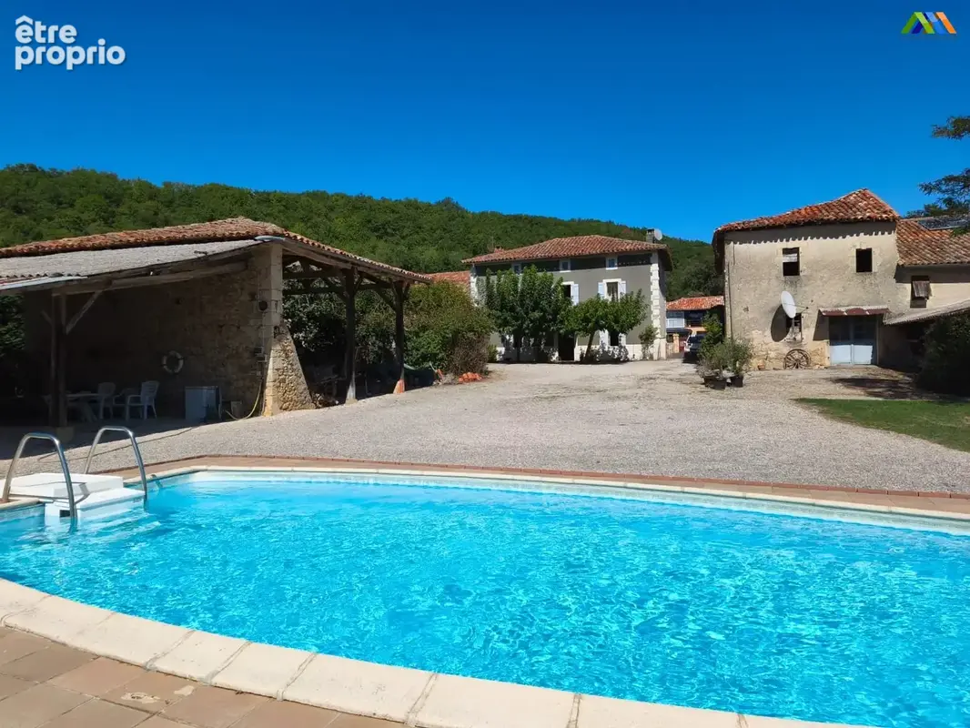 Swimming pool and outdoor space overlooking the grounds of this country house in Southwest France.