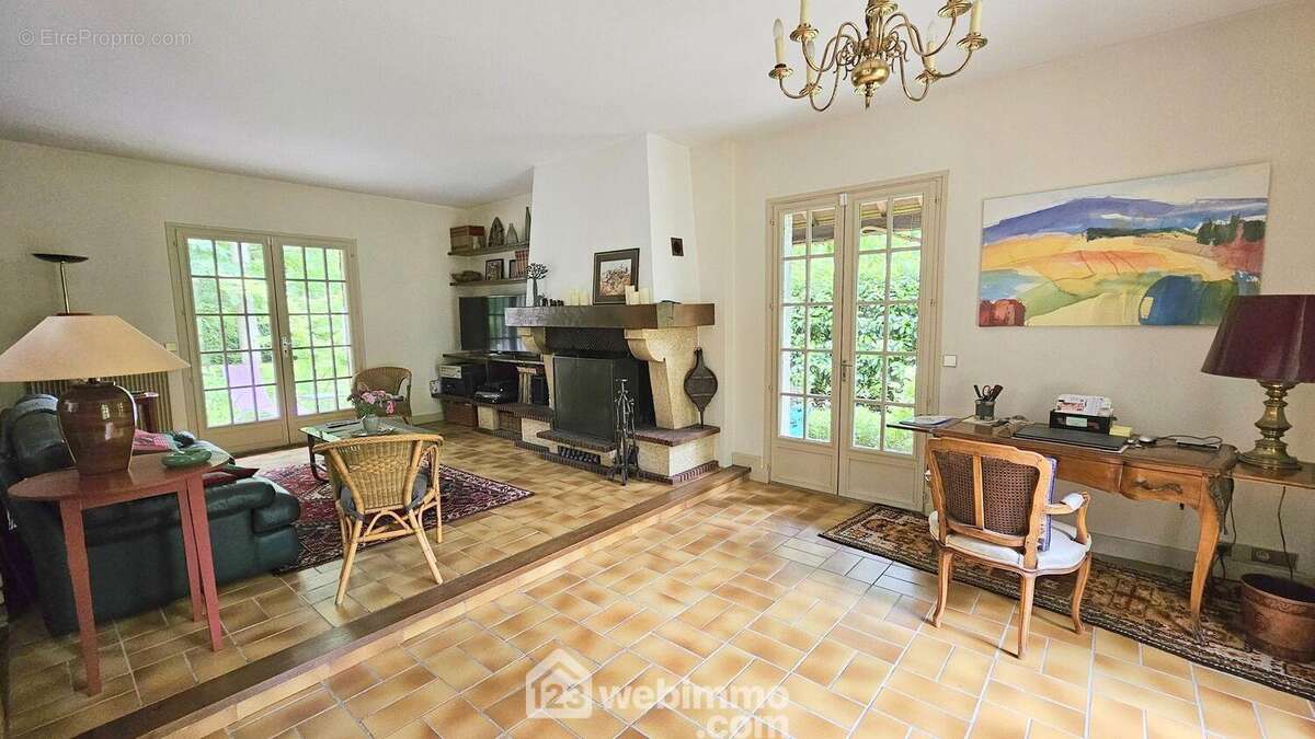 Un séjour de 30 m² avec sa cheminée ouverte.