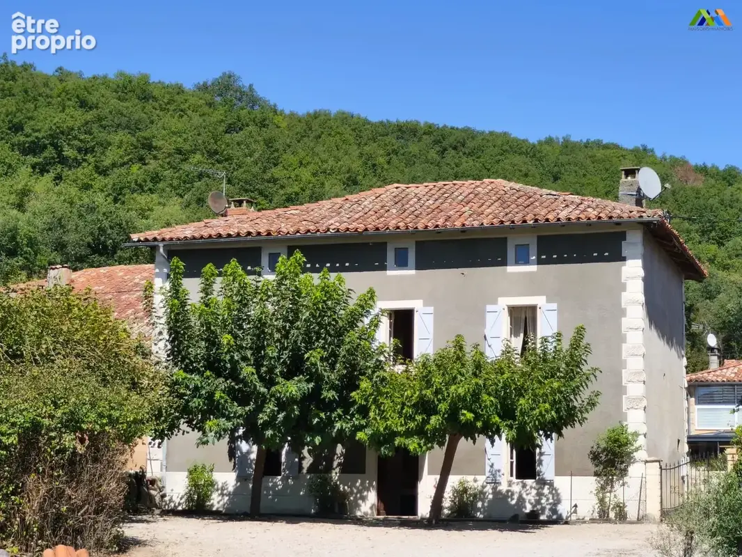Traditional village house near Aurignac, Haute-Garonne, with a leafy garden and countryside setting.