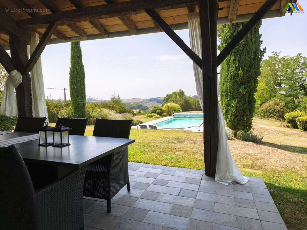 Covered terrace overlooking the pool and peaceful garden.