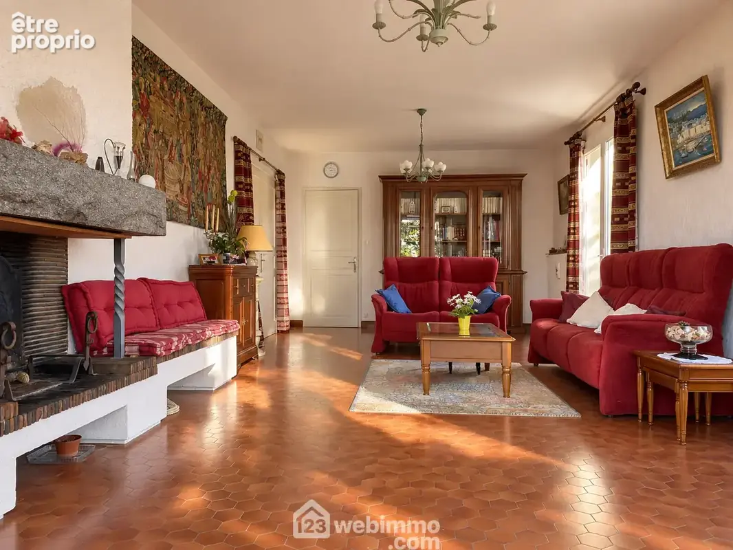 Le salon et sa cheminée à foyer ouvert