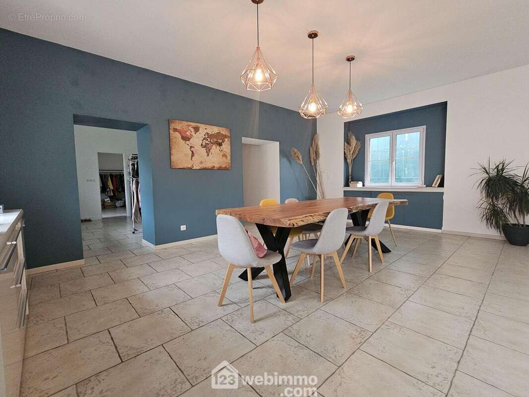 Un coin repas moderne et élégant, au c½ur de la maison - Maison à BOUFFIGNEREUX