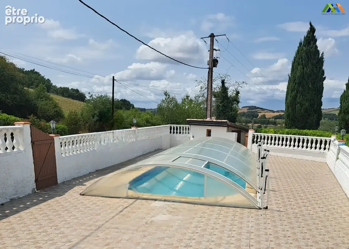 Covered swimming pool with spacious sun terrace and countryside setting