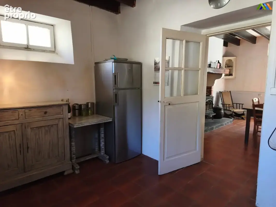 Country-style kitchen with timber details, generous storage and access to the adjoining rooms.